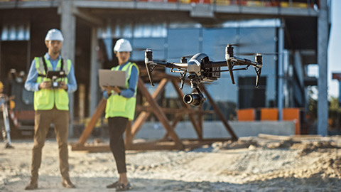 Work health and safety representatives conducting a workplace inspection using drone technology