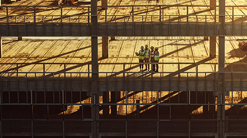 Diverse team of specialists inspecting high rise construction site