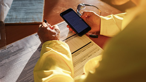 An over the shoulder view of a contractor filling in paperwork