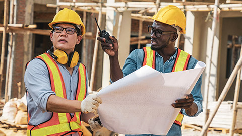 Two construction workers engaging in a disagreement on site