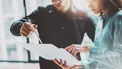 Business colleagues discussing paperwork for a construction job