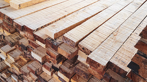 A stack of wood planks waiting to be used in a construction project