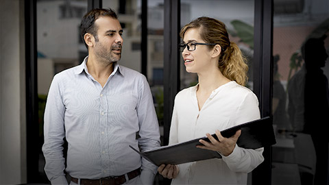 Man and woman talking outside the business office