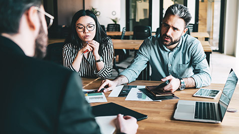 An auditor talking to a client about financial records