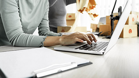 Woman's hand on computer, inventory