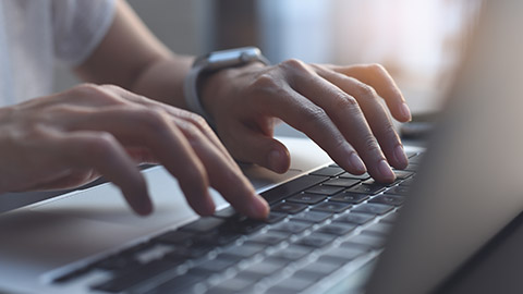 A person typing on a laptop