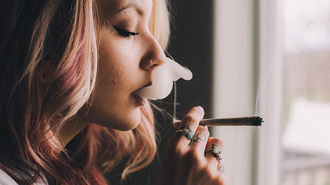 A person smoking a cannabis joint