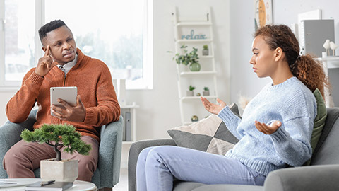 Psychologist working with African-American woman in office