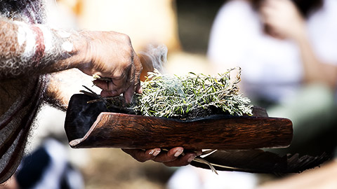 An aborigine starting a fire