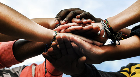 diverse group hands together as a team