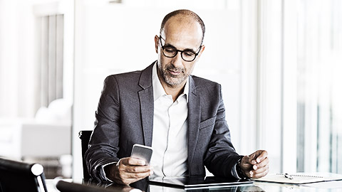 A professional using a tablet to compute procurement costs