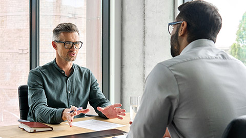 Two diverse business executive partners negotiating