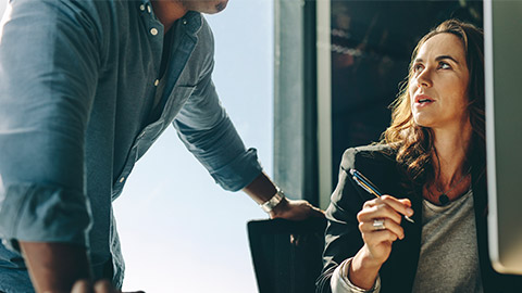 usiness executives working together at office desk