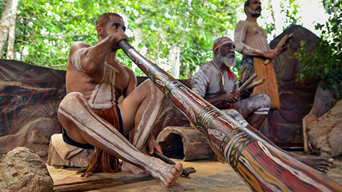 Aboriginal men play Aboriginal music on didgeridoo and wooden instrument during Aboriginal culture show