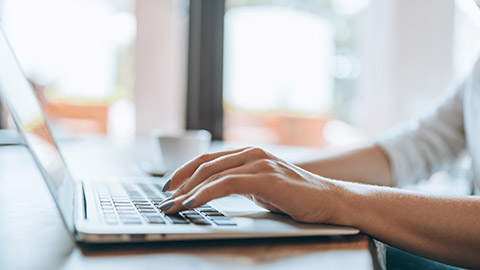 A person typing on a laptop