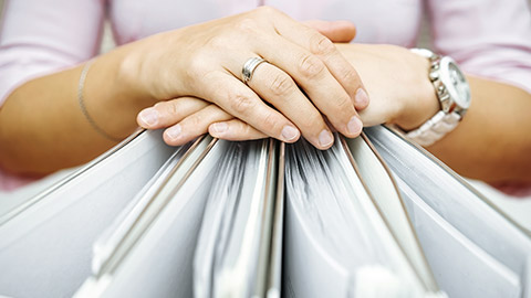 hands resting on documents