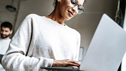 woman with eyeglass using laptop