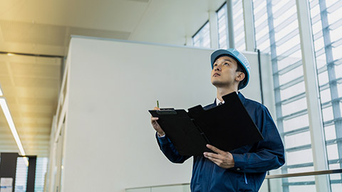 a young man doing a maintenance inspection at the office