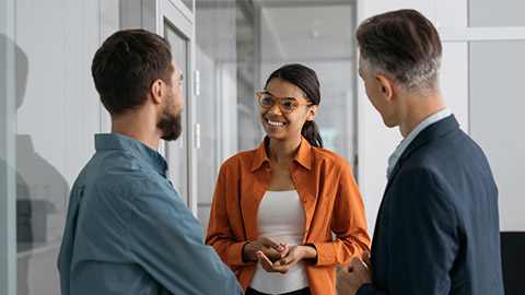 Confident African American woman explaining something, communication with business colleagues in office