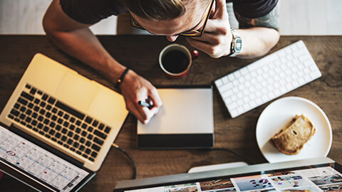 Top down view of a small business owner working on marketing materials