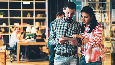 2 colleagues discussing a business contract on a tablet device