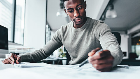 A project manager working on project paperwork