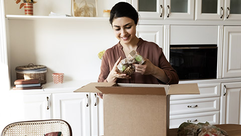 A person happily unpacking their online purchases