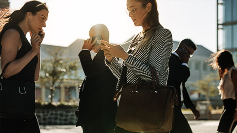 A candid shot of people walking on the streets using their phones