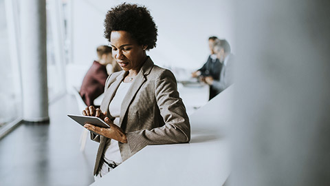 A business owner relexly cheking on their tablet