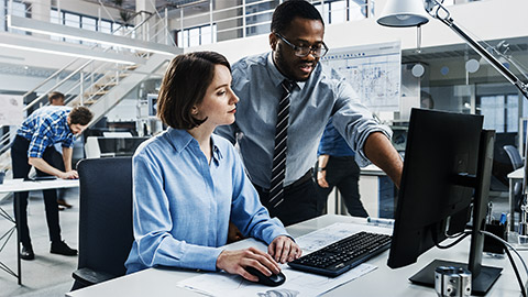 A supervisor guiding one of the QA employees