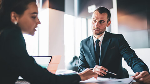 A manager discussing business issues with a colleague