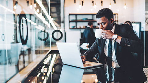 A business analyst working on a laptop