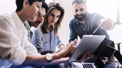 A group of employees being taught how to use business tools and technologies