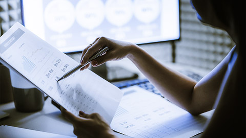 A person preparing a report of the social media performance