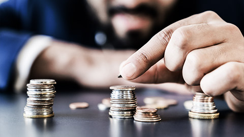 A person counting coins