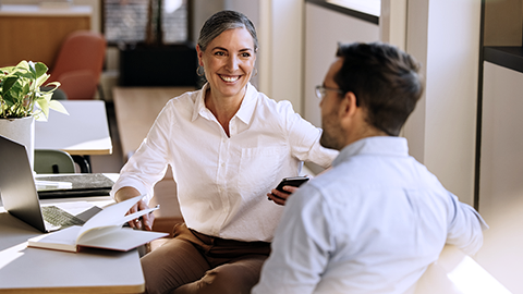 Business partners sitting at desk and discussing