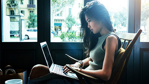 a person answering online questions on laptop