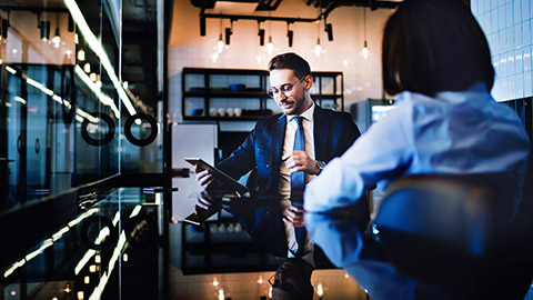 manager discussing business a presentation with colleague in a company office room