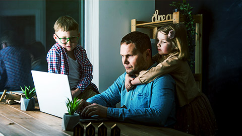 a person working from home with children around