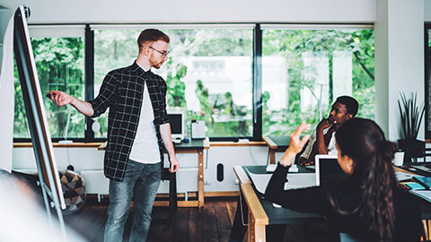 A manager giving a training presentation to coworkers