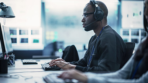 African American Computer Engineer Finds and Fixes Bugs in a Product or Program Before the Launch.