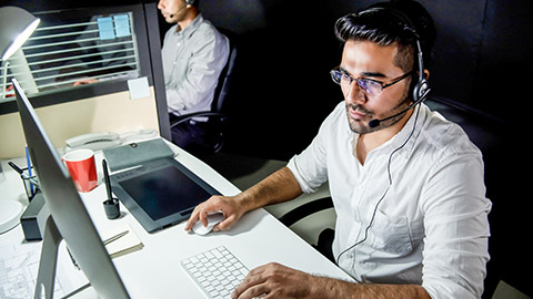 Asian technical support team working night shift in call center office talking with customers in different time zone