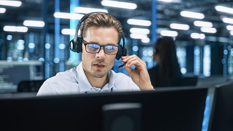 Customer Support Operator in Headset Video Calling on Computer at Evening Office. Call Center Agent, Service Support Manager Speaking to Distance Customer in Webcam Chat. Helpline Concept