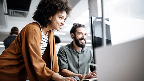 Happy workers looking at the computer