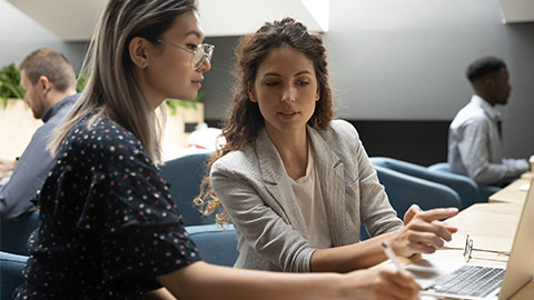 manager instructing asian trainee