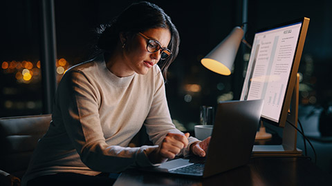 A person working on a document in an office at night