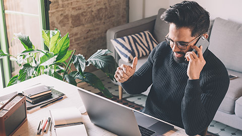 Bearded coworker man working at living room at home