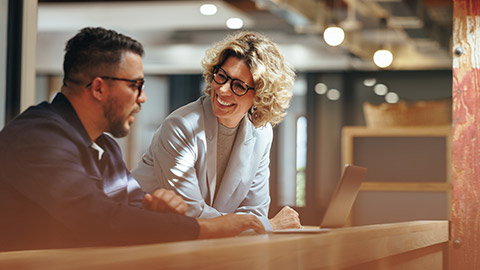 Colleagues discussing business in an office