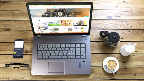 A laptop on a desk with a website on the screen