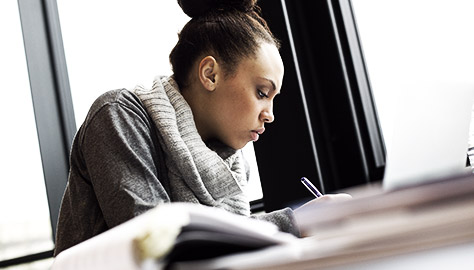 A person taking notes on a presentation